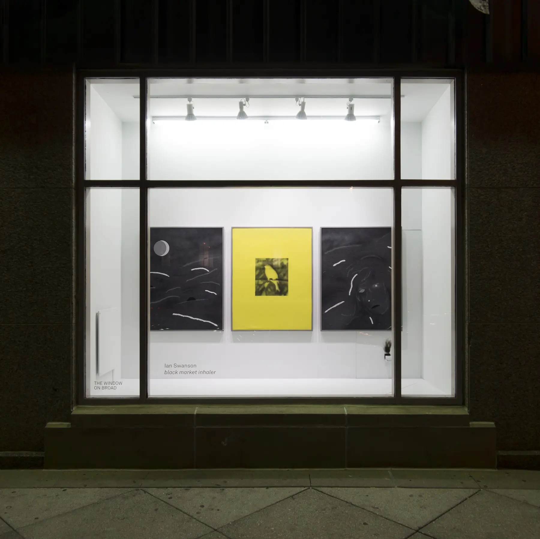 Black Market Inhaler viewed through the Window on Broad storefront at night