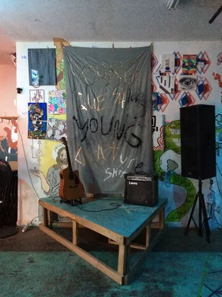 Trade in Trade Up installation with painted fabric, stage, and sound equipment